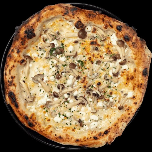 Nardò Italian Restaurant's white pizza with mushrooms, ricotta, and herbs on a dark background.