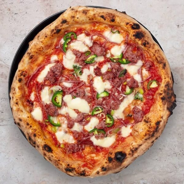 Nardò Italian Restaurant's pizza with sausage, mozzarella, tomato sauce, and sliced green peppers.