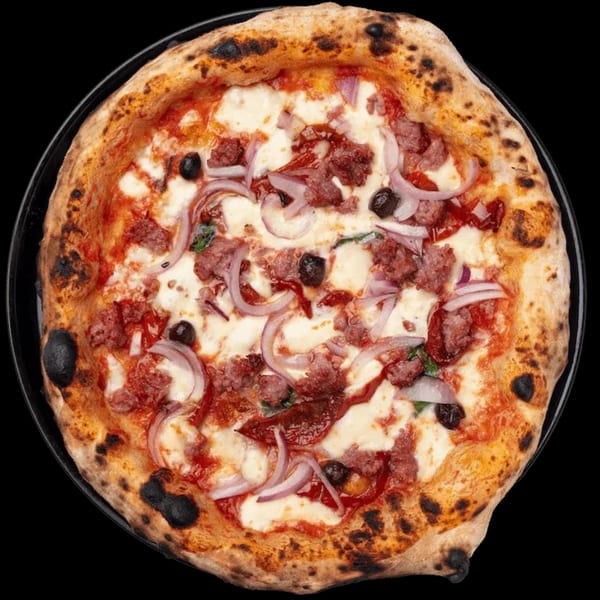 Nardò Italian Restaurant's pizza with sausage, red onion, and black olives on a dark background.