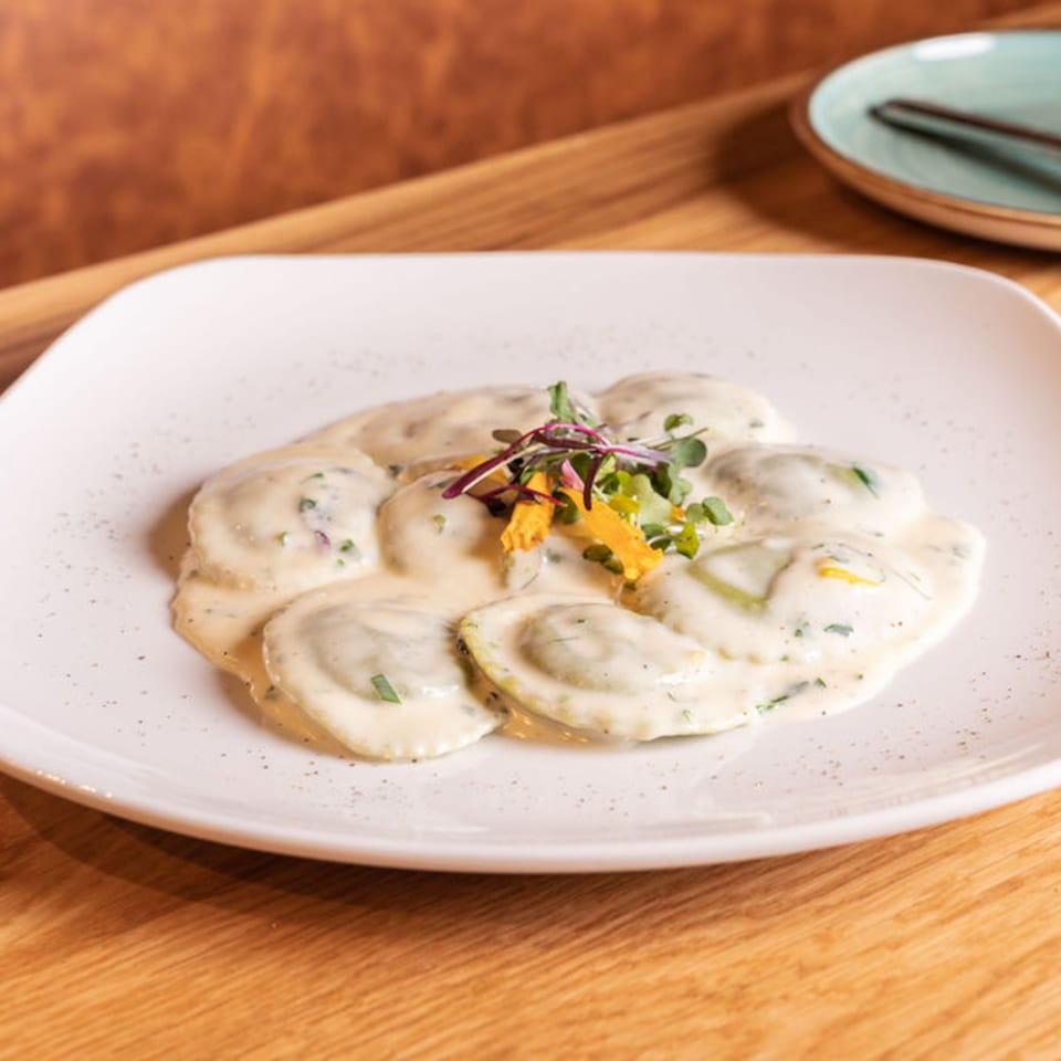 Nardò Italian Restaurant's ravioli dish, served with a creamy sauce and garnished with fresh herbs.