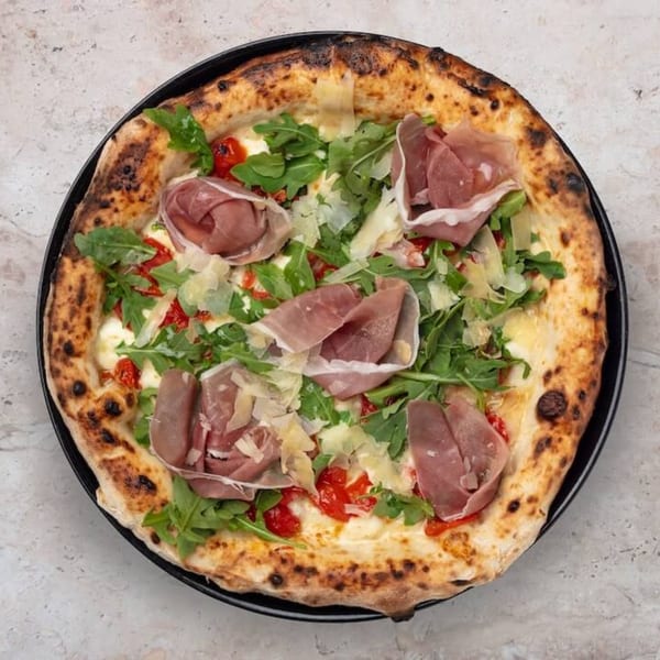 Nardò Italian Restaurant's pizza with prosciutto, arugula, cherry tomatoes, and parmesan cheese.