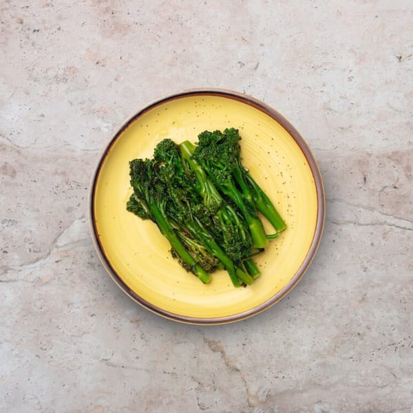 Nardò Italian Restaurant's broccolini side dish, served on a yellow plate.