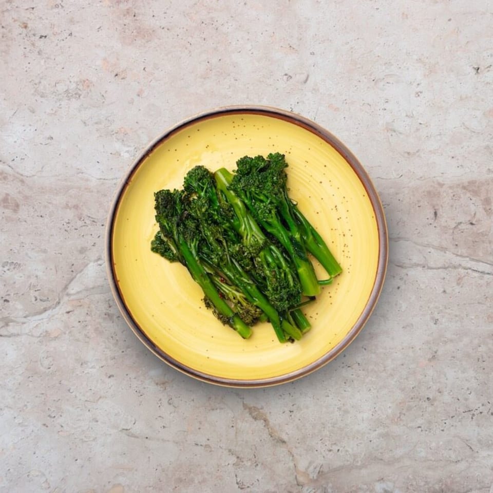 Nardò Italian Restaurant's broccolini side dish, served on a yellow plate.