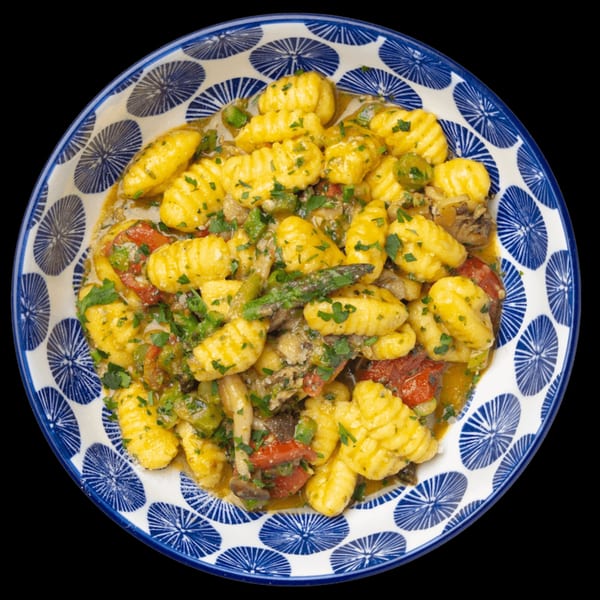 Nardò Italian Restaurant's gnocchi with vegetables, mushrooms, and herbs in a blue and white patterned bowl.