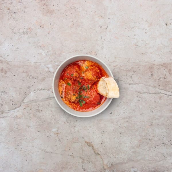 Nardò Italian Restaurant's meatballs in rich tomato sauce with fresh parsley and a side of bread.